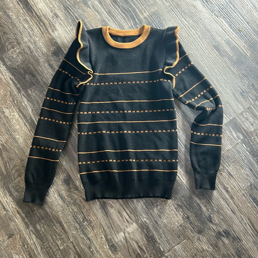 Black and tan sweater with a cute ruffle shoulder, size small.